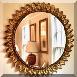 D28. Round sunburst mirror. 